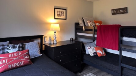 Bedroom with queen bed and twin bunks. Bedroom with queen bed and twin bunks.