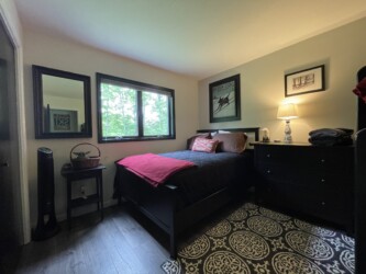 Bedroom with full bed and twin bunks
