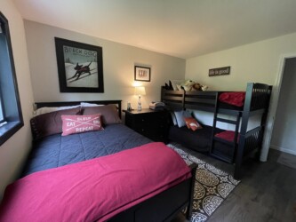 Bedroom with full bed and twin bunks